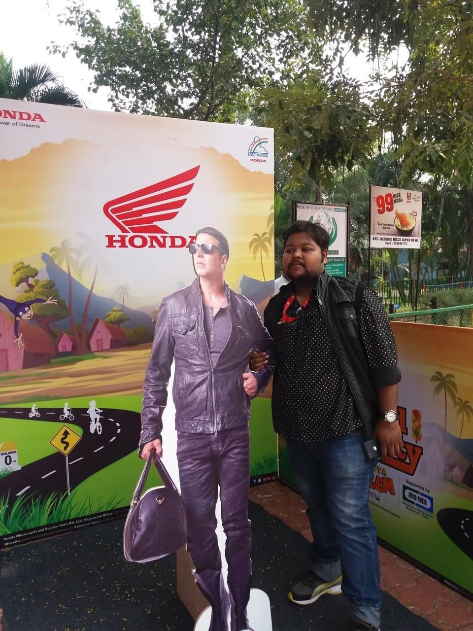 Brand activation photo-op with a life-size cut-out and illustrated backdrop for visitor photographs