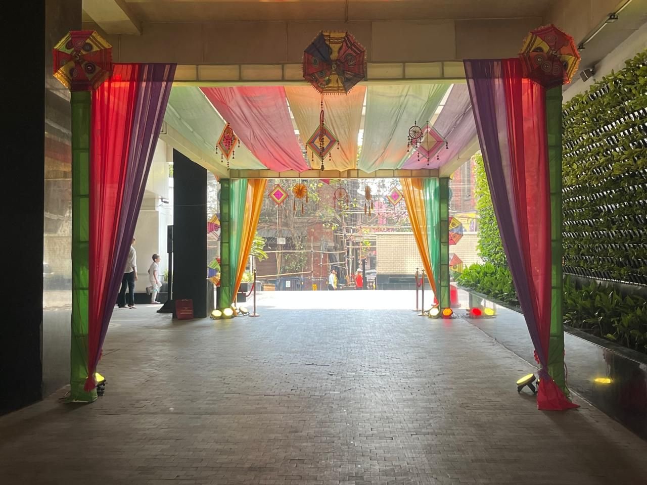 Entrance corridor dressed with colourful drapes, lanterns and hanging decor
