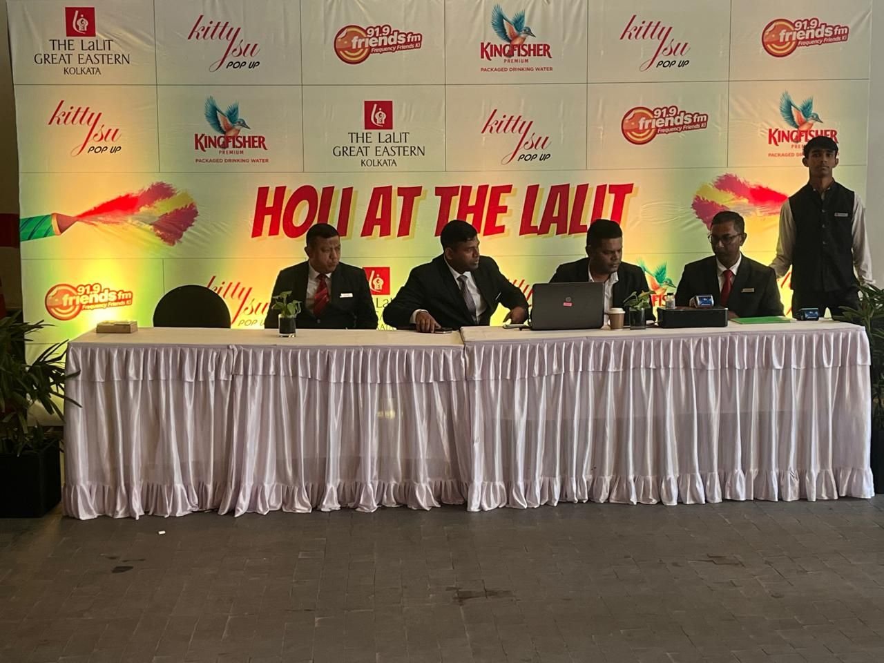 Guest registration counter in front of a co-branded festival backdrop